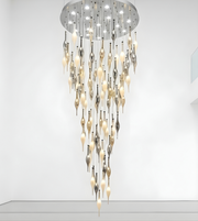Modern chandelier with glass droplet design on a white background