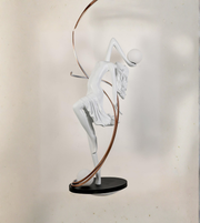 White abstract sculpture on a black base against a neutral background