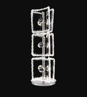 Decorative lamp with square glass panels on a black background