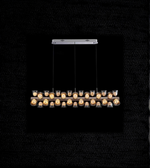 Modern pendant light fixture with glass cover on a black background