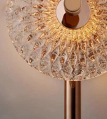 Close-up of a decorative lamp with a textured glass shade and metallic base.