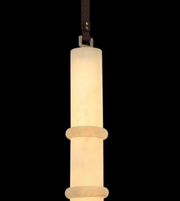 Pendant light fixture with cylindrical design on a black background