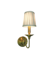 Wall-mounted lamp with a white shade on a white background