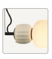 Modern wall light fixture with a round beige shade on a white background