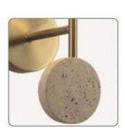 Close-up of a gold handle attached to a textured beige circular object.