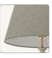 Textured lampshade with a gold fixture on a white background