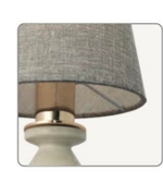 Lamp with a gray shade and metallic base on a white background