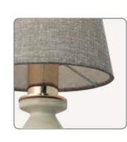 Lamp with a gray shade and metallic base on a white background