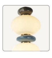 Decorative light fixture with spherical design on a white background
