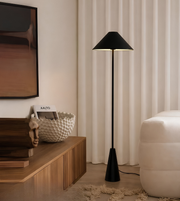 Modern living room with a black floor lamp, wooden console table, and white curtains.