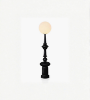 Black decorative lamp with a white bulb on a white background