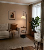 Cozy living room with a beige sofa, lamp, and plant