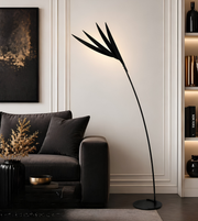 Modern living room with a black floor lamp, gray sofa, and decorative items.