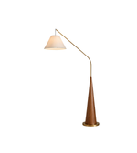 Floor lamp with wooden base and curved arm on a white background