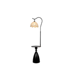 Black floor lamp with a decorative lampshade on a white background