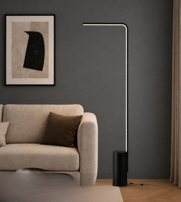 Modern floor lamp in a living room setting with a sofa and artwork on the wall.