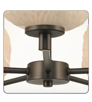 Close-up of a ceiling fan with bronze finish and glass shades.