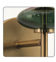 Decorative wall light fixture with green glass shade and gold metal base.