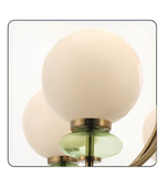 Decorative wall light fixture with spherical glass shades on a white background