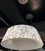 Speckled patterned pendant light fixture on a dark ceiling