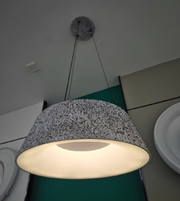 Pendant light with textured shade on a ceiling