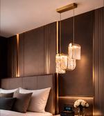 Modern bedroom with a stylish headboard, pendant lights, and decorative elements.