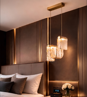 Modern bedroom with a stylish headboard, pendant lights, and decorative elements.