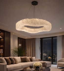 Modern chandelier hanging above a living room with a cityscape view.