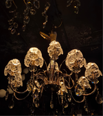 Crystal chandelier with intricate design against a dark background