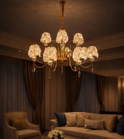 Luxurious chandelier hanging in a dimly lit room with a sofa and armchair.