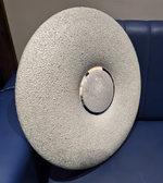 Round textured lampshade on a blue sofa