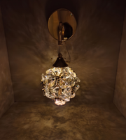 Wall-mounted light fixture with crystal ball design on a dark background