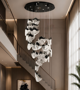 Modern chandelier hanging in a stylish interior setting with a staircase and window.
