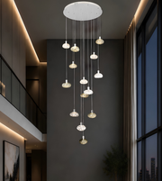 Modern pendant light fixture hanging from a ceiling in an indoor setting.