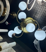 Ceiling light fixture with gold and bronze finish on a dark surface
