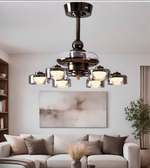 Modern chandelier in a living room setting with a sofa and artwork on the wall.