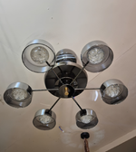 Modern chandelier with multiple light fixtures on a ceiling.