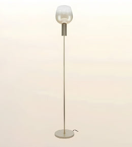 A modern floor lamp with a slim metallic pole, a round base, and a frosted glass shade on a plain light beige background.