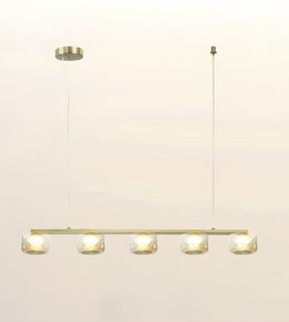 A modern linear chandelier with five clear glass shades and warm white LED lights, suspended from a slim cable with a round canopy on a plain off-white background.