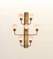 Modern brushed gold wall sconce featuring seven frosted globe lights mounted on a sleek cylindrical metal frame.