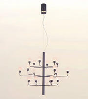 A modern multi-light chandelier with a matte black metal frame and multiple frosted glass globe bulbs, suspended from a matching black ceiling canopy against a plain off-white background.