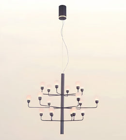 A modern multi-light chandelier with a matte black metal frame and multiple frosted glass globe bulbs, suspended from a matching black ceiling canopy against a plain off-white background.