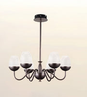 A six-light chandelier with an oil-rubbed bronze finish and textured frosted glass shades, shown against a soft beige gradient background.