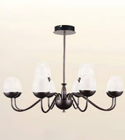 A six-light chandelier with a dark bronze metal frame and textured white glass shades, shown against a plain beige background.