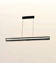A modern linear LED ceiling light fixture suspended by two thin cables from a rectangular ceiling mount, shown against a plain off-white background.