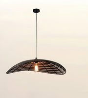 A modern pendant light with a curved black metal frame and a single glowing warm bulb, suspended against a plain light beige background.