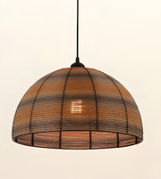 A dome-shaped pendant light with a woven natural rattan shade and a black metal frame, suspended by a black cord against a plain off-white background.