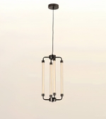 A modern multi-light linear pendant chandelier with four vertical frosted glass tubes and a dark metal frame, suspended from a circular ceiling canopy against a light beige background.