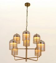 Luxury eight-light smoked glass chandelier with brushed brass frame and smoked glass dome shades for modern living rooms, dining spaces, hotel lobbies, and luxury interiors.