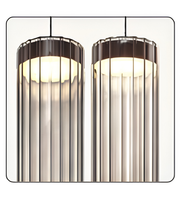 Two cylindrical pendant lights with ribbed glass shades on a white background